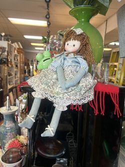 Vintage-style rag doll features curly auburn hair