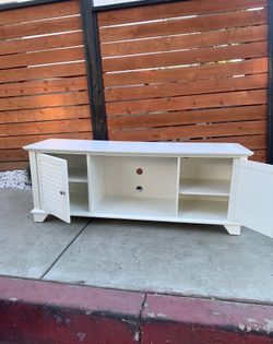 White tv cabinet/stand in good shape minor scratches adjustable shelves 60 inches wide 18 inches depth 22 1/4 height
