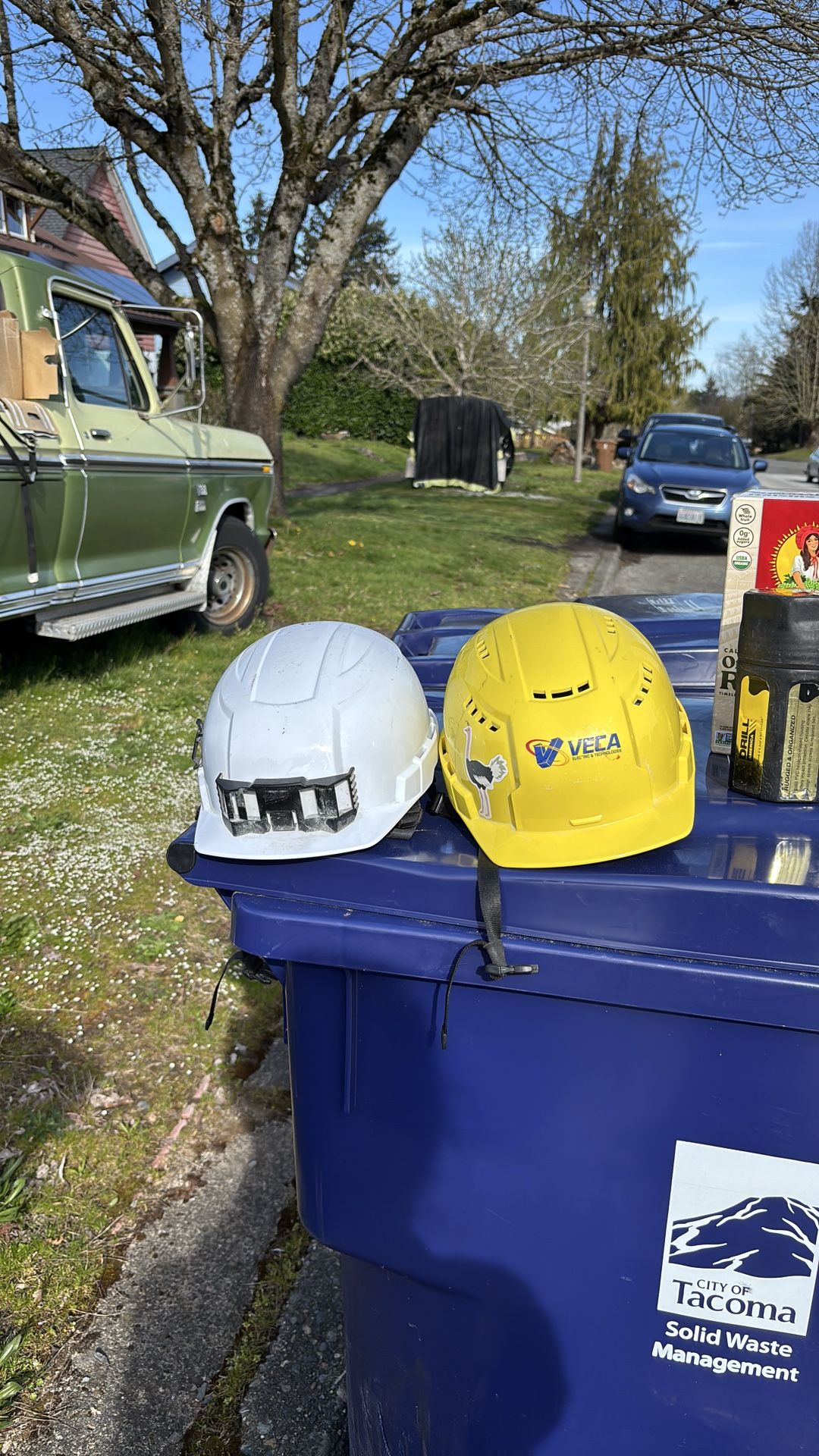 Two Milwaukee bolt hard hat helmets