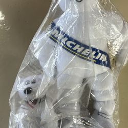 This item is a vintage-style Michelin Man (Bibendum) plush advertising collectible, featuring a small pup mascot and still in its original packaging. 