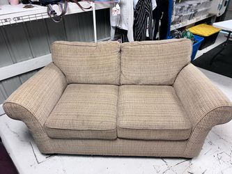 Brown comfy love seat couch.