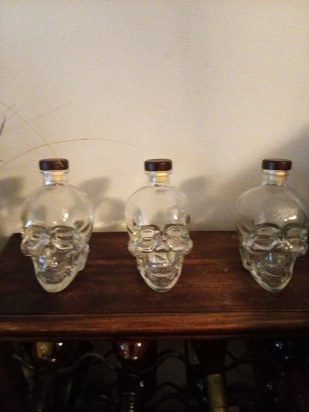 Three Empty Skull Head Bottles