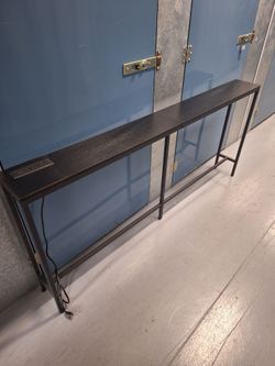 Behind the couch stand/shelf