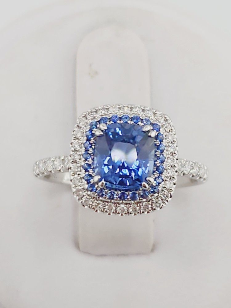 18k white gold 1.40ct blue sapphire ring with 0.08ct sapohire halo and 0.24ct diamonds