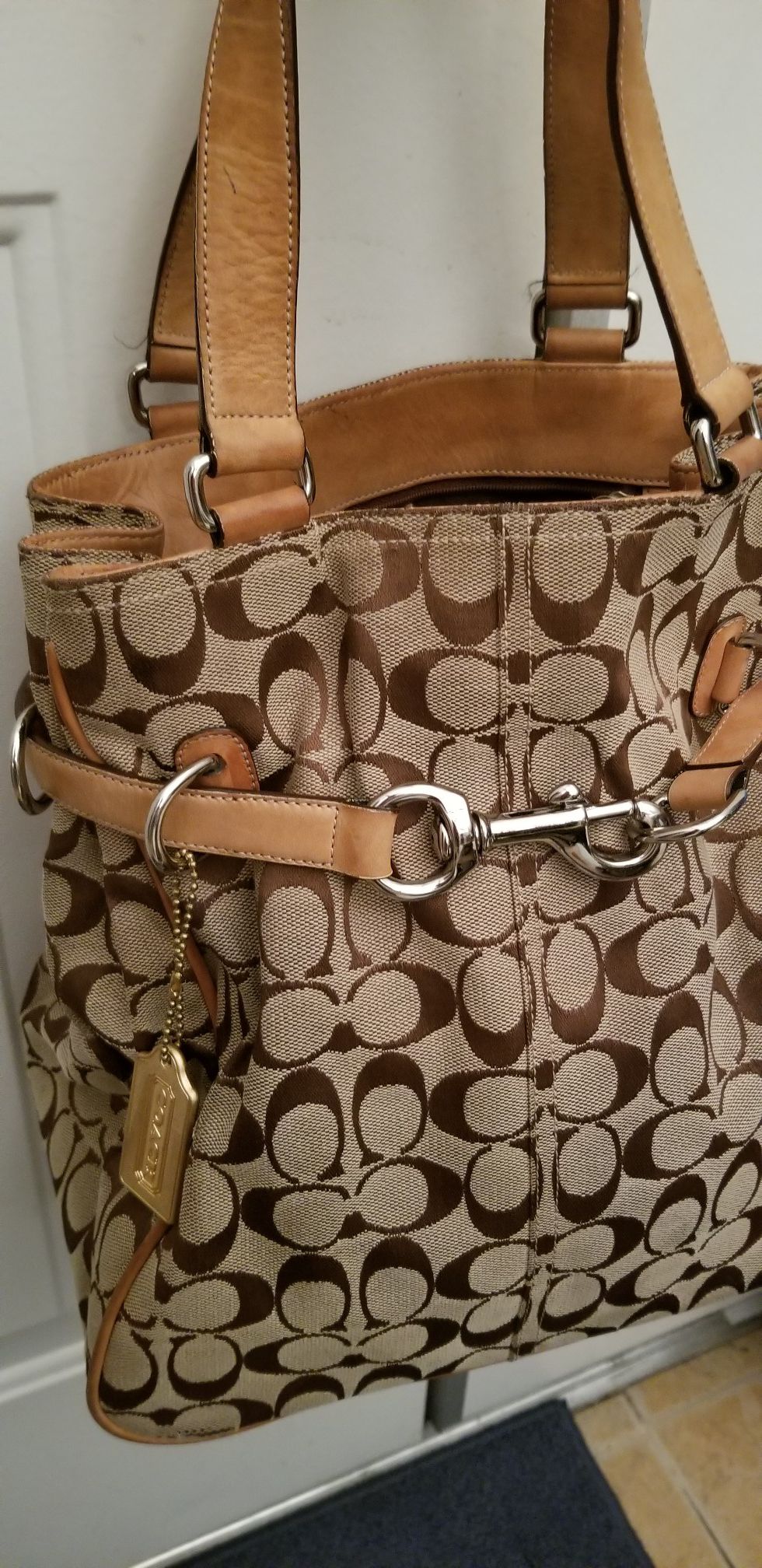 Handbag by Coach. Used good condition. $22Canvas & leather.Style Belted Carryall Tote.Clean just has some Use, can be nicely cleaned w Leather cleaner