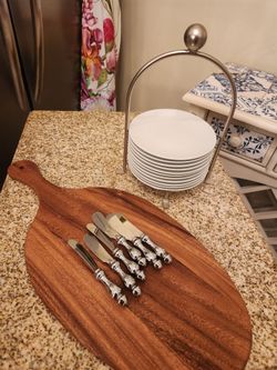 Charcuterie board, cheese knives, and plates