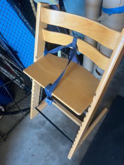Stokke Tripp Trapp high chair in a natural wood finish.