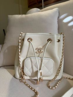 Elegant White Bucket Bag with Gold Chain and Quilted Front Pocket