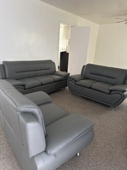 New 3 Piece Gray Leather Living Room Set. Sofa, Love Seat, And Chair.