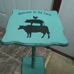 Wood table!  Says.. Welcome To The Farm.