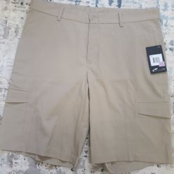 Pair of Nike Dri-FIT men's golf cargo shorts in beige/khaki.  Men's 34