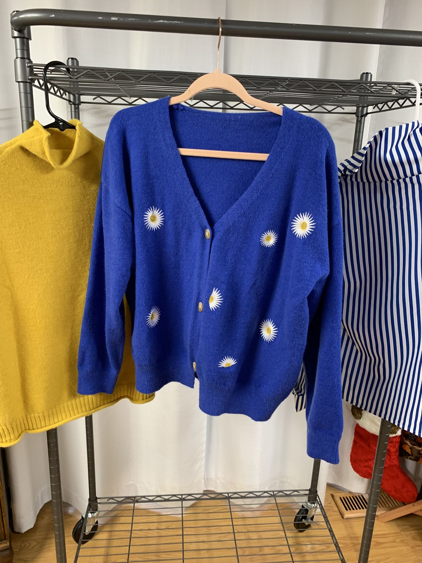 Gold Knit Vest, Royal Blue Cardigan With Daisys, And Royal Blue And White Striped Shirt With Buttons Down The Arm