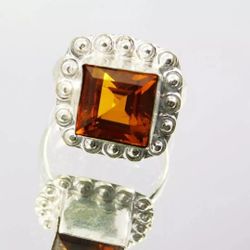 Size 7 Rare 28.45 Ct Orange Sapphire Like Corundum 925 Sterling Silver Ring. This stunning ring features an orange sapphire like corundum gemstone wit