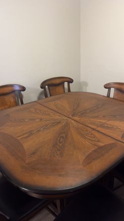 vintage wooden dining table expandable with six cushioned chairs