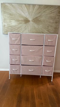 White /pink dresser with 12 drawers.