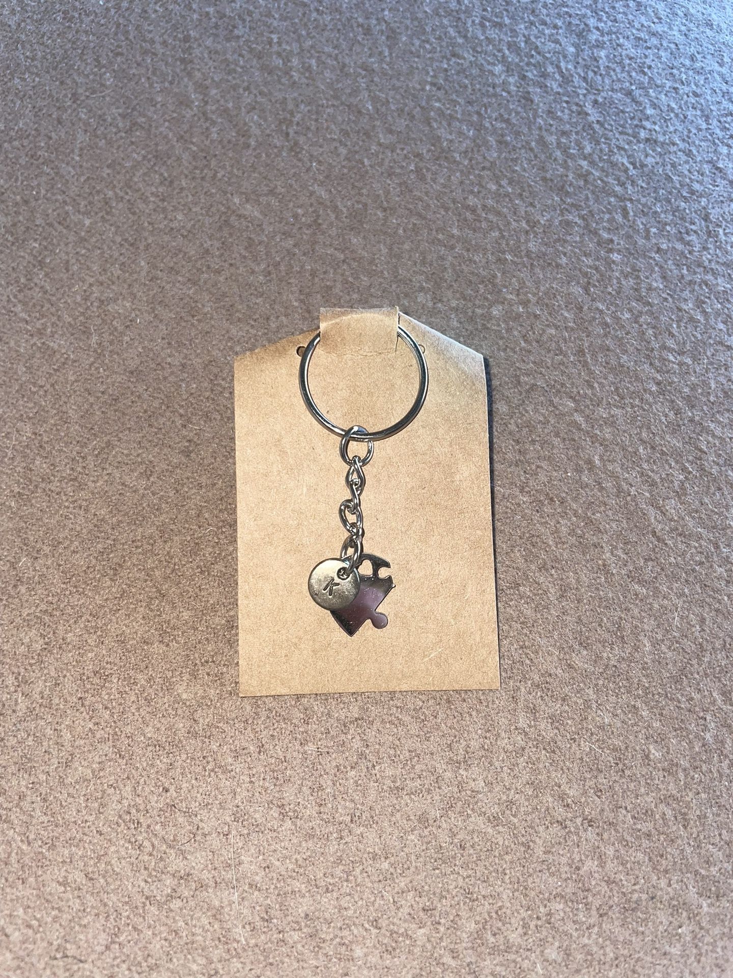 Puzzle Piece “K” keychain with a heart cutout