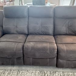 Gray reclining sofa with two recliners. Very comfortable and in great condition. (Ashley)