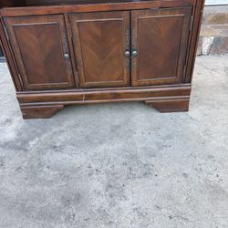 A Brown Wood Entertainment Center / TV Stand, in good condition