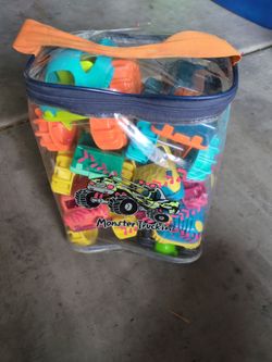 Carried bag of toy monster trucks