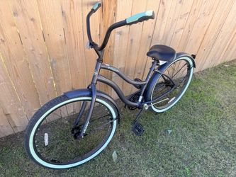 26-inch Huffy Cranbrook Comfort Cruiser bike in matte dark navy blue with mint green accen