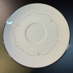 Noritake Whitebrook saucer, featuring a white floral and gray scroll pattern with platinum trim