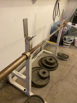 Bench/ squat rack with barbell and plates