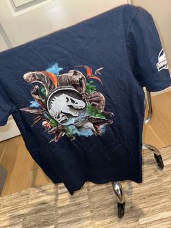 “Jurassic World : Rebirth”   Exclusive, Rare, Collectible T-Shirt  (slap bracelet included!)  Size: MEDIUM   NEW