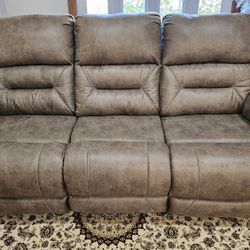 Brand New Reclining three seat power sofa.