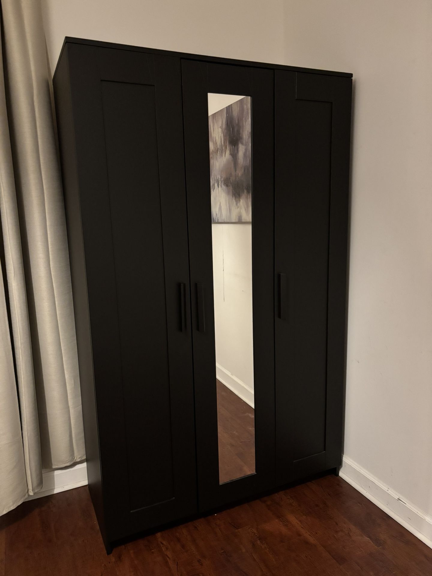Stylish black wardrobe closet with mirror