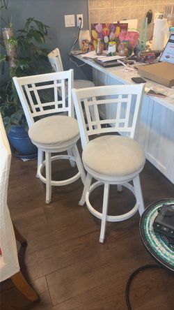 Two wooden swivel stools