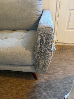 Comfortable Living Spaces couch with wear