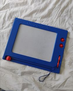 This is a Cra-Z-Art Retro Magna Doodle blue magnetic whiteboard with a red pen.