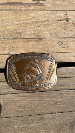 Bronze old ironsides in the defense of freedom belt buckle.