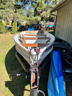 Rowboat with trailer oars anchor life jacket