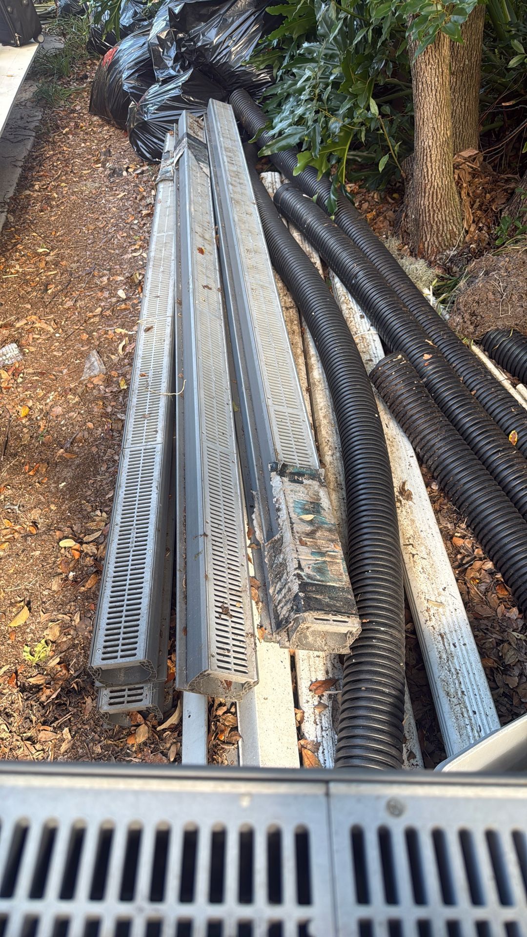 French Drain System And Unused White Gutters