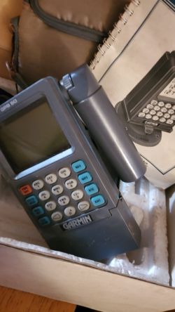 vintage Garmin GPS 50 Personal Navigator handheld device with its original owner's manual