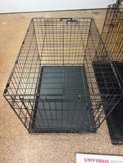 Dog crate and a vehicle pet barrier