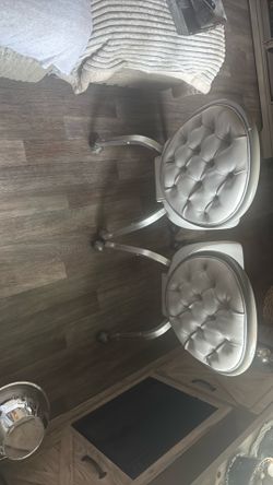 Light grey leather rolling office chairs with pearl detail on outside back rest