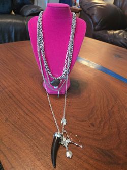 Free People Multi-strand silver-tone necklace from Free People. Features a black horn pendant, brown stone charm, and mixed silver accents. Lightweigh