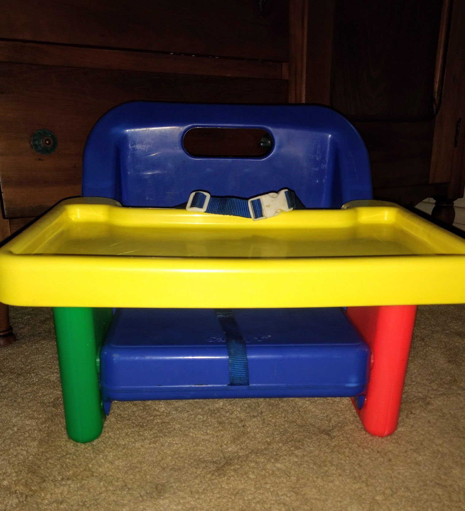 multi-colored booster seat, w/ sliding tray & safety belt