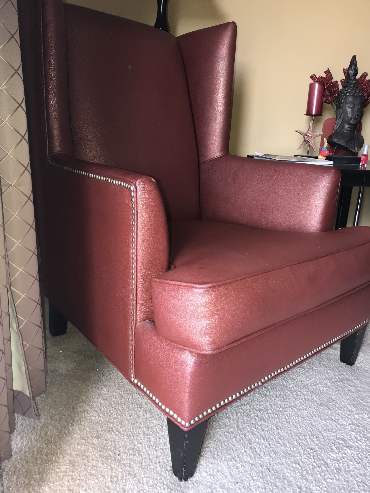Terra cotta colored leather arm chair with studs