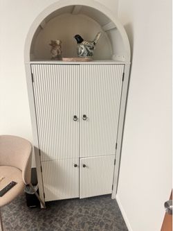 White distressed painted arched cabinet
