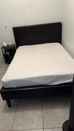 Full-size bed with mattress and nightstands