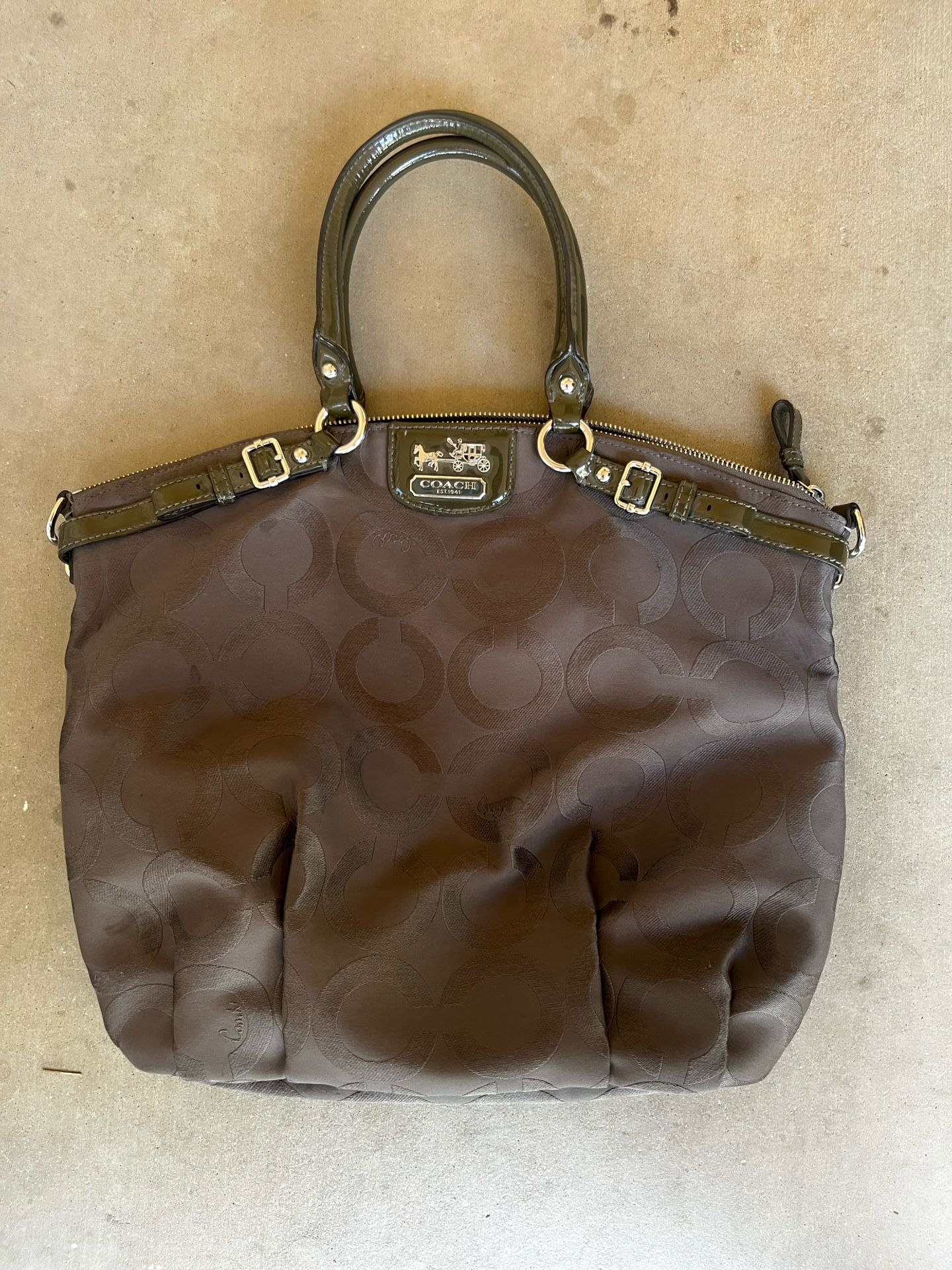 Really pretty brown coach bag with green accents and purple inside
