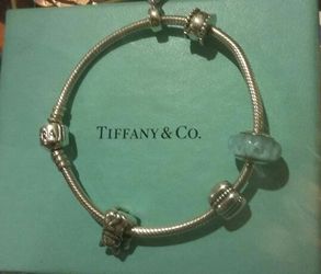Pandora bracelet w/3 charms and 2 stoppers