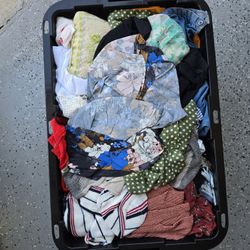 Containers of new with tags and gently used Women's clothes
