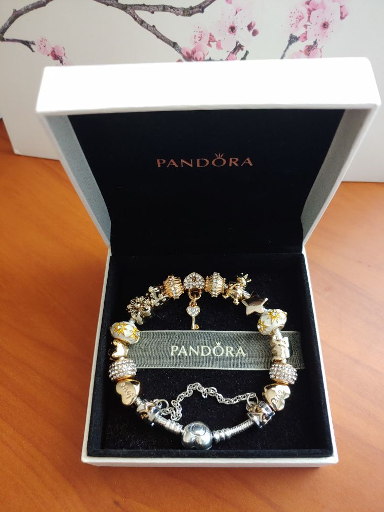 New in box Authentic Pandora Bracelet with golden European Charms