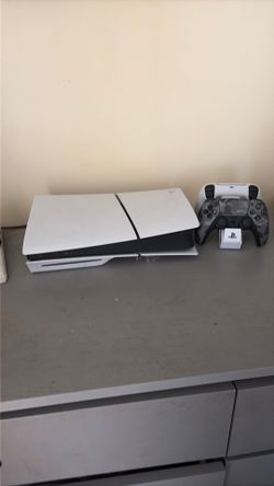 PS5 console with two controllers and games