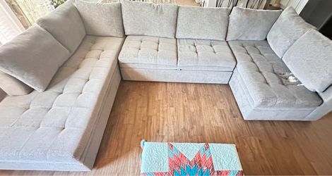 Large Grey Sectional with pullout couch.