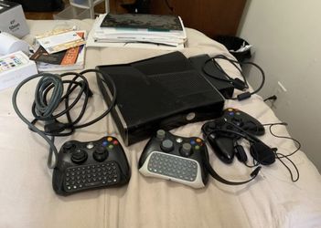 Xbox 360 plus controllers headsets and two games